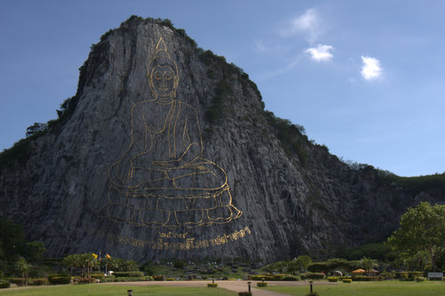 Giant Golden Buddha in stone at Kaho Chee Chan cliff